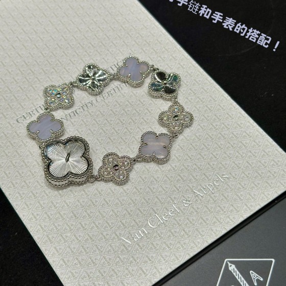 Van Cleef & Arpels watch with silver dial, diamond-set clover motif, and white mother-of-pearl.